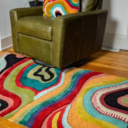 Handmade Abstract Rug showcases abstract pattern with freeform curves. Whether you're looking to add a splash of color, adorn your OEKO-TEX
